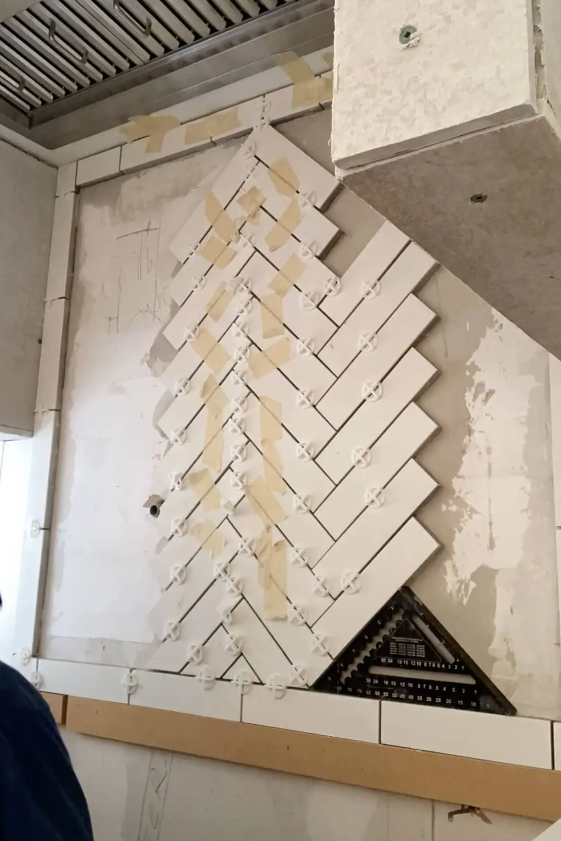 DIY herringbone tile backsplash.